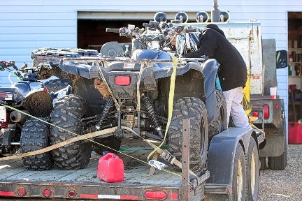 ATV crating and securing on trailer with straps for transport and shipping services in Georgia.