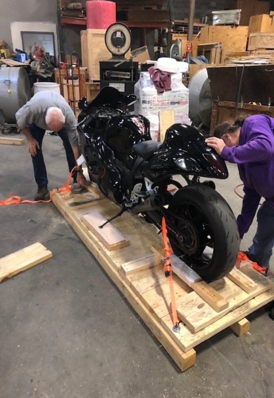 The motorcycle is getting prepared for shipping with secure crating in Georgia and surrounding areas